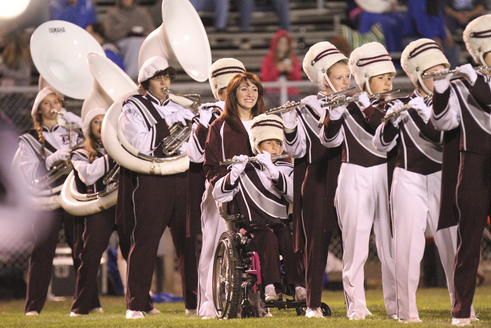 William D LEwis The Vindicator Boardman band member Kaitlin Windt, in wheelchair,  gets help from Rachael Ruggieri during 11012013 halftime show.