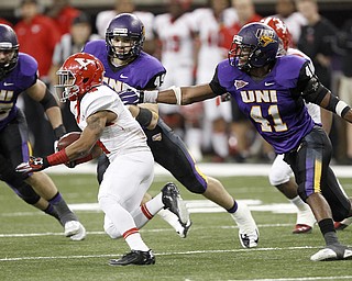 Northern Iowa's Sam Tim gets a hand on Youngstown State's Andre Stubbs in the backfield during in the first half of the game at the UNI-Dome in Cedar Falls, Iowa, Saturday, Nov. 9, 2013.