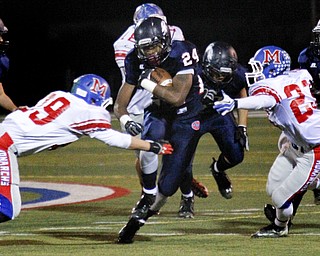 MADELYN P. HASTINGS | THE VINDICATOR..Fitch's Darrin Hall (24) runs with the ball while Marysville's Ty Stiers (29) and Sam Tse (23) try to tackle him during their game on November 9, 2013.... - -30-..