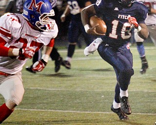 MADELYN P. HASTINGS | THE VINDICATOR..Fitch's Antwan Harris (18) runs with the ball while Marysville's Kenny Kinder (27) attempts to stop him during their game on November 9, 2013.... - -30-..