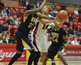 Youngstown State #14 Karen Flagg attempts to pass the ball while VCU #24 Robyn Parks and #34 Keira Roberts pressure her burring the pass.