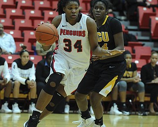 Youngstown State #34 Latisha Walker dribbles down the lane to the basket after getting around VCU #44 Camille Calhoun.