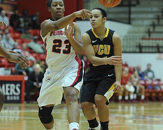 Youngstown State #23 Melissa Thompson passes the ball to a tam mete to avoid the pressure from VCU defender #21 Ashlee Mitchell during the first half of Saturday afternoons game.
