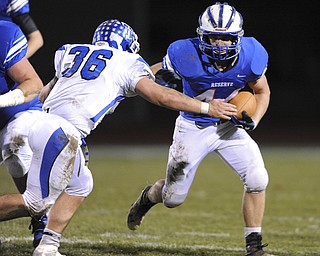 Reserve running back #44 Dan Zilke runs the football around the outside while Trinity #36 Antonio Capasso attempts to tackle him during the 1st quarter of Saturday nights game.