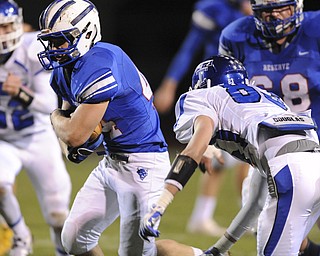 Reserve running back #44 Dan Zilke runs the football away from Trinity defensive back #83 Jacob Walters during the 1st quarter of Saturday nights game.