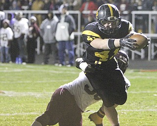 Crestview's Jake Ferris (41) reaches out across the goalline to score before being dragged down by Liberty's Darrel McLendon (60) during the second quarter of Saturday's OHSAA playoff game at Crestview High School. Dustin Livesay | The Vindicator 11/9/13 Crestview High School.
