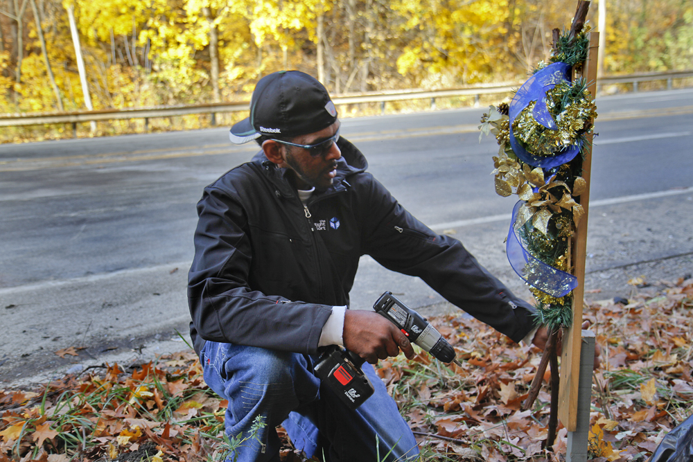 MADELYN P. HASTINGS | THE VINDICATOR..Vincent Campbell of Ferrel, PA places a decorated cross at the site of a two vehicle car accident along Connelly Blvd. near the intersection of Route 62. The accident caused three deaths with four others injured at around 10:00 p.m. on Friday, November 10, 2013.  ... - -30-..