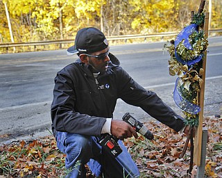 MADELYN P. HASTINGS | THE VINDICATOR..Vincent Campbell of Ferrel, PA places a decorated cross at the site of a two vehicle car accident along Connelly Blvd. near the intersection of Route 62. The accident caused three deaths with four others injured at around 10:00 p.m. on Friday, November 10, 2013. ... - -30-..