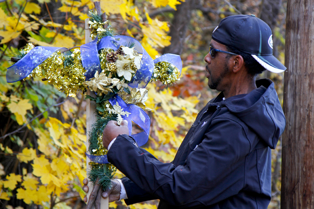 MADELYN P. HASTINGS | THE VINDICATOR..Vincent Campbell of Ferrel, PA places a decorated cross at the site of a two vehicle car accident along Connelly Blvd. near the intersection of Route 62. The accident caused three deaths with four others injured at around 10:00 p.m. on Friday, November 10, 2013.  .... - -30-..