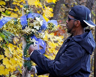 MADELYN P. HASTINGS | THE VINDICATOR..Vincent Campbell of Ferrel, PA places a decorated cross at the site of a two vehicle car accident along Connelly Blvd. near the intersection of Route 62. The accident caused three deaths with four others injured at around 10:00 p.m. on Friday, November 10, 2013. .... - -30-..