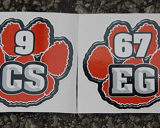 MADELYN P. HASTINGS | THE VINDICATOR..Initials C.S. for Corey Swartz and E.G. for Evan Gill are marked on stickers which the Sharon High School football team will wear on their helmets in honor of their lost teammates in a fatal car accident Friday night. ... - -30-..