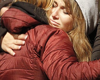 MADELYN P. HASTINGS | THE VINDICATOR..Kayla Reardon hugs a loved one during a candle light vigil held at the Sharon High School stadium on November 10 mourning the deaths of a fatal car accident occurring November 8.... - -30-..