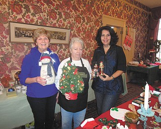 SPECIAL TO THE VINDICATOR
Darlene Bennett, left, Susan Stoddart and Susan Pappas are displaying some of the items that will be for sale at the Upton Association holiday garage sale from 9 a.m. to 4 p.m. Friday and Saturday. Donations can be dropped off from 9 a.m. to noon Thursday at Upton House, 380 Mahoning Ave., Warren. Proceeds will be used to maintain the home. For public or private rentals call 330-395-1840.