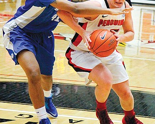 Youngstown State’s Heidi Schlegel tries to keep Buffalo’s Cherridy Thornton from stealing the ball during
their Horizon League game Wednesday at YSU’s Beeghly Center. Schlegel had a team-high 23 points with nine
rebounds for the Penguins, who dropped to 0-2 on the season with a 72-65 loss to the Bulls.