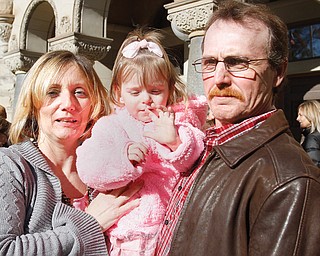 Neal and Michele Shaffer of Hubbard hold the newest permanent member of their family — 2-year-old Isabella. They adopted her Thursday at the Trumbull County Courthouse during the annual Adoption Day Celebration sponsored by the Trumbull County Probate Court and Trumbull County Children Services.