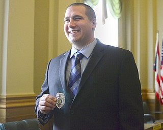 Jeffrey Kay of Howland sports his badge after he was sworn in as an officer with the Youngstown Police Department. The department welcomed four new officers at a ceremony in city council chambers Thursday.