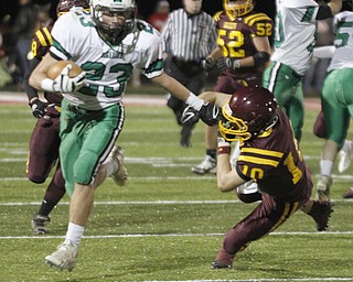 . ROBERT K. YOSAY | THE VINDICATOR..Mogadore #23 Dominik (ok) Pizzino. puts a stiff arm to #10 SR Greg Dunham as he scampers for a first half first down..South Range and Mogadore in Minerva Ohio .....-30-