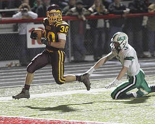 . ROBERT K. YOSAY | THE VINDICATOR..#30 Joe Alessi runs out of the grasp of #3 Mogadore Brendon Schrock for South Range first TD on their first possesion.. South Range .South Range and Mogadore in Minerva Ohio .....-30-