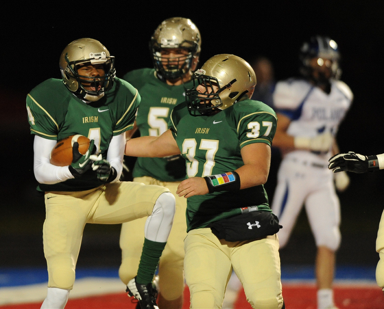 St. Vincent - St. Mary #4 Jarel Woolridge celebrates with teammate #37 Joe Faetanini and #51 Alec Bianci after scoring a touchdown on the first series of the game during Friday nights game in Ravenna. Poland #11 Dylan Garver pictured.