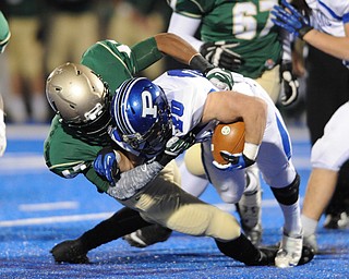 Poland #20 Ross Gould is tackled and dragged down to the ground by St. Vincent - St. Mary #47 Dante Booker during Friday nights game in Ravenna.