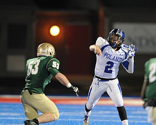 Poland quarterback #2 Dom Petrony throws a pass while avoiding pressure from St. Vincent - St. Mary #53 Anthony Adkins during Friday nights game in Ravenna.