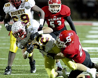 William D Lewis The Vindicator Mooney's Mark Handel(22) is stopped by Struthers Nick Pollifrone(21) in background is wildcat Derrick Reber(53) during playoff action Friday in Niles.