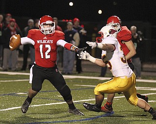 William D Lewis The Vindicator Struthers' QB Gary Muntean(12) is pursued by Mooney's Anthony Dermotta(35) during playoff action Friday in Niles.
