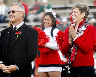MADELYN P. HASTINGS | THE VINDICATOR..Ellen Tressel claps for her husband Jim after being inducted into YSU's Hall of Fame at half time of the YSU vs. NDSU game at Stambaugh Stadium on November 16, 2013.... - -30-..