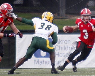 MADELYN P. HASTINGS | THE VINDICATOR..YSU's Dante Nania (3) runs with the ball from NDSU's Carlton Littlejohn (38) during their game at Stambaugh Stadium on November 16, 2013. The Penguins lost to Bisons 17-35..... - -30-..