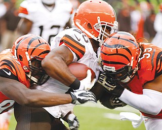 Browns RB Chris Ogbonnaya fumbles as he is hit by Bengals defenders Vontaze Burfict (55) and defensive end
Wallace Gilberry (95) during the second quarter of Sunday’s game in Cincinnati. Burfict recovered the ball and
returned it for a touchdown. The Bengals scored three more times in the second quarter to set a team record and
breezed to a 41-20 victory.