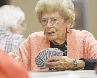 Jean Orin participates in Hand and Foot Game Night, playing a game that many players compare to canasta.