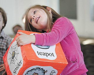 Ava Lombardo, 3, of Austintown uses the song block during a learning exercise at Gotta Move Story Time.