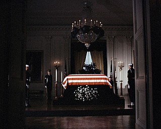 The flag-draped casket of President John F. Kennedy lies in state in the East Room of the White House in Washington, Nov. 23, 1963.  