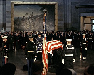 The flag-draped casket of President John F. Kennedy lies in state in the East Room of the White House in Washington, Nov. 23, 1963. 