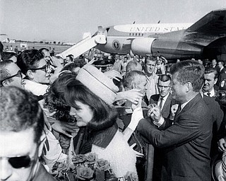President Kennedy and the first lady Jacqueline Kennedy receive an enthusiastic welcome as they arrive in Dallas Love Field, Nov. 22, 1963.  Later that day the president was assassinated as his motorcade moved through the city. 
