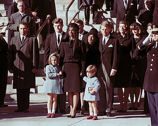 The First Family watches John F. Kennedy's funeral procession in Washington on Nov. 25, 1963, three days after the president was assassinated in Dallas. Widow Jacqueline Kennedy, center, daughter Caroline Kennedy, left, and son John Jr., are accompanied by the late president's brothers Sen. Edward Kennedy, left, and Attorney General Robert Kennedy. 