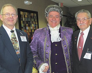 SPECIAL TO THE VINDICATOR
William E. Johnson, dressed as the Colonial patriot John Hancock, stands between retired Lt. Col. Rod Hosler of Boardman, left, and retired Maj. Peter Mihai of Youngstown. At a recent meeting of the Mahoning and Shenango Valleys Chapter of the Military Officers Association of America, Johnson was the guest speaker. He offered a glimpse of colonial history in Hancock’s persona. An actor in the stage play “1776,” Johnson also has written two fictional historical books about colonial days: “Snug Harbor Tavern” and “Seeds of Love — and War.” A former Navy aviator, Johnson lives in Youngstown and gives seminars nationwide. The next MSVC-MOAA meeting will take place jointly with the Mahoning Valley Chapter of the Reserve Officers Association Dec.8 at the Manor Restaurant, at the corner of state Route 46 and Kirk Road in Austintown. For reservations call 330-568-4456.