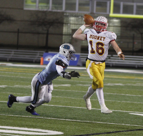  .          ROBERT  K. YOSAY | THE VINDICATOR..Mooneys QB  Jon Saadey goes airborne to get off a first down pass during second quarter action as chasing him is #4 Benedictines Jerome Baker..Cardinal Mooney Cardinals vs Cleveland Benedictine Bengals in Solon.....-30-