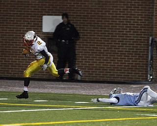  .          ROBERT  K. YOSAY | THE VINDICATOR..Mooneys #2 C J Amil breaks the last tackle of  Dom Berdysz  for Benedictine as he goes in for 6 after a 40 + yard run and a TDCardinal Mooney Cardinals vs Cleveland Benedictine Bengals in Solon.....-30-