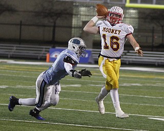  .          ROBERT  K. YOSAY | THE VINDICATOR..Mooneys QB  Jon Saadey goes airborne to get off a first down pass during second quarter action as chasing him is #4 Benedictines Jerome Baker..Cardinal Mooney Cardinals vs Cleveland Benedictine Bengals in Solon.....-30-