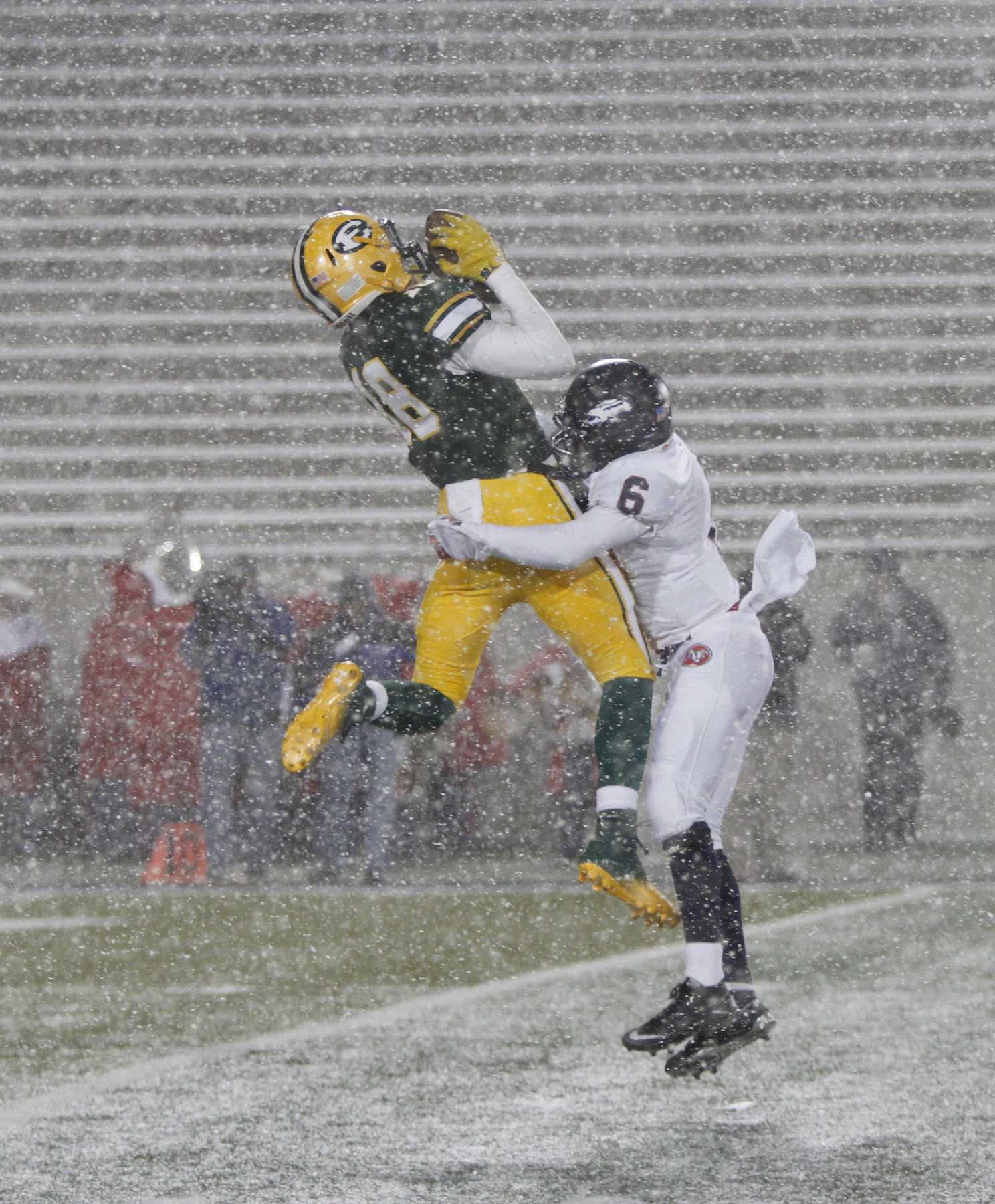  .          ROBERT  K. YOSAY | THE VINDICATOR..In blinding Snow   Fitchs #6 Rodney Smith brings down #18  St Eds David Dowell after receiving  a first down pass during second quarter action ..Austintown Fitch and St Edwards at Infocision in Akron.....-30-