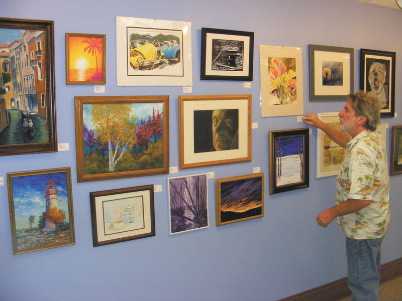 SPECIAL TO THE VINDICATOR: 

More than 100 pieces of original art are for sale on the first floor of Trumbull Memorial Hospital, 1350 E. Market St., Warren, in the Nissen Gallery. Local artists will be the feature of the 2013 Trumbull Area Artists Holiday Show. Each piece is priced at $100 or less. Purchases can be made through Peg Krozier in the hospital’s administration office or by calling 330-841-1900. The display will run through Jan. 2. Above is James Hardy of Warren, who assisted hanging the art for the show.
