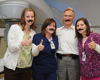 Charleen Howell, left, Sheri Pluchinsky, Dr. Eric Svenson and Becky Marlatt of Partners for Urology Health in Austintown recently sported fake mustaches but thumbs-up for the Movember cause.