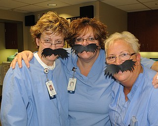 Michelle McBride, left, Emilie Doneyko and Debbie Ferrell, nurses in same-day surgery at St. Elizabeth Hospital, showed their support for Movember.