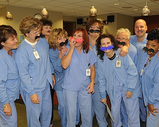 Nurses in the same-day surgery unit at St. Elizabeth Hospital joined in Movember fun. They include, from left, Becky Rainey, Michelle McBride, Cathy Chambers, Diane Brenner, Mary Ann Smith, Emilie Doneyko, Gail Conrieote, Debbie Ferrell, Ratico Pusic and Marva Jones.