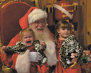 Bev Craig of Salem took this picture at the annual visit to see Santa. Her granddaughter Bianca, 3, was excited about the visit. Her sister Marissa,1, just wanted to go back home to Wooster. Santa loved it.