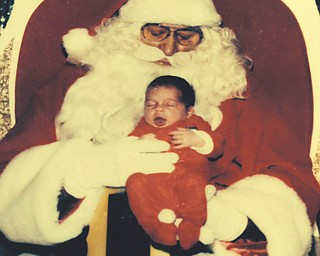The baby pictured with Santa is Michelle Hatzileris, who resides in Youngstown. She was two weeks old when this picture was taken in 1984 at the Southern Park Mall in Boardman. The photo was submitted by her mother, Karen Hatzileris.