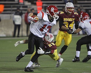 Steubenville's Lucas Herrington (17) gets wrapped up by Cardinal Mooney's Joe Kleeh (29) during the first quarter of Friday nights Division four Semi-Finals matchup at Fawcett Stadium in Canton.  Dustin Livesay  |  The Vindicator  11/29/13  Fawcett Stadium, Canton.