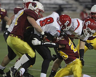 Nick Hubert (47) and Joe Kleeh (29) of the Cardinal Mooney defense bring down Steubenville quarterback Mandela Lawrence-Burke (8) during the first quarter of Friday nights Division four Semi-Finals matchup at Fawcett Stadium in Canton.  Dustin Livesay  |  The Vindicator  11/29/13  Fawcett Stadium, Canton.