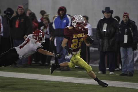 Cardinal Mooney's Mark Handel (22) eludes a tackle by Steubenville's Bryan Pierro (7) during the second quarter of Friday nights Division four Semi-Finals matchup at Fawcett Stadium in Canton.  Dustin Livesay  |  The Vindicator  11/29/13  Fawcett Stadium, Canton.